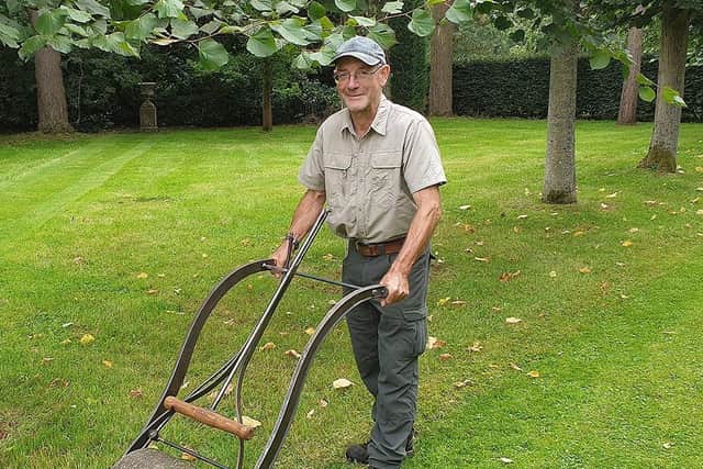 Clive Gravett, curator of the Museum of Gardening at South Downs Nurseries, Hassocks, with a replica of Edwin Beard Buddings' lawn mower. Picture: TBPR
