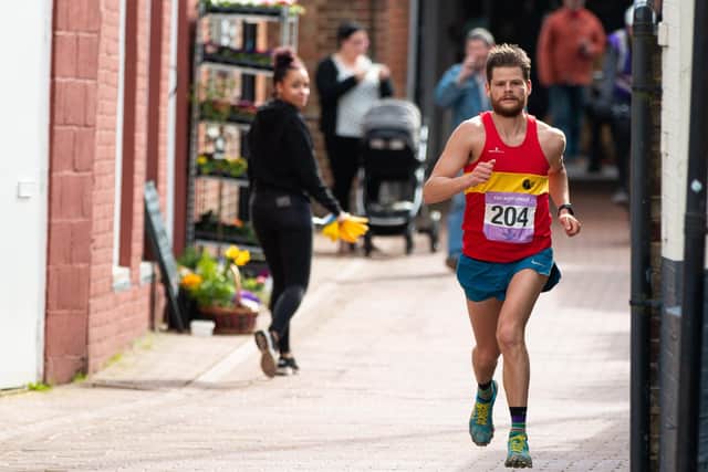 Lewes AC runner James Turner heading for the finish line last year. Photograph: Barry Collins