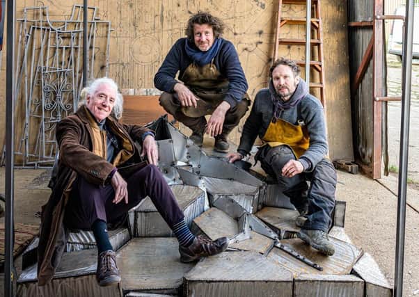 Patrick Kealey, sculptor Leigh Dyer and technical assistant James Dyer on the sculpture. Photo by Peter Mould