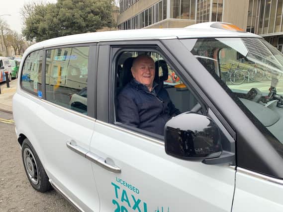 Driver Tony Turner in his new electric taxi
