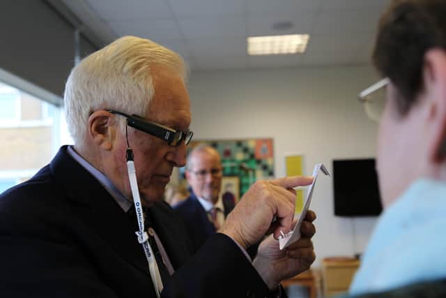 David Dimbleby being shown some of the equipment provided by Blind Veterans UK