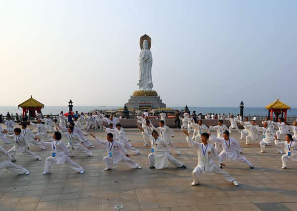 Tai Chi exponents performing Tai Chi Chuan during a cultural festival for the martial art in Sanya, southern China's Hainan province.  Photo: STR/AFP via Getty Images