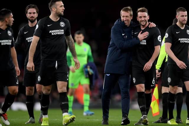 Brighton head coach Graham Potter congratulates his players after victory at Arsenal