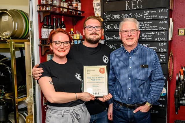 Mike and Jo Saveen, owners of The Fox & Finch in Worthing, are presented with the award for Pub of the Year 2020 from Arun and Adur CAMRA