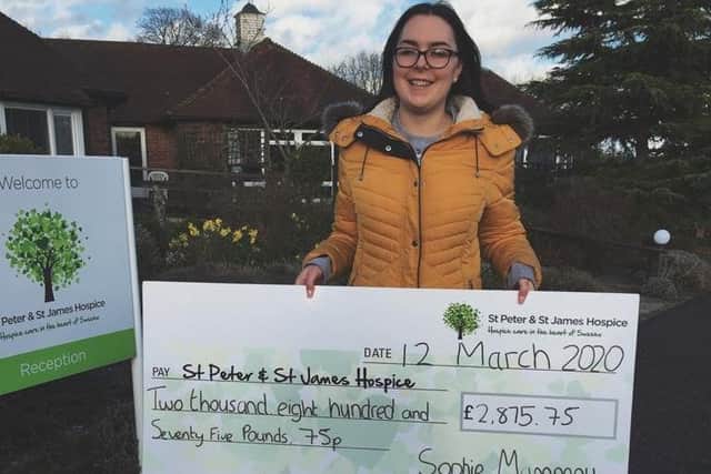 Sophie Mamoany with the cheque for St Peter and St James Hospice