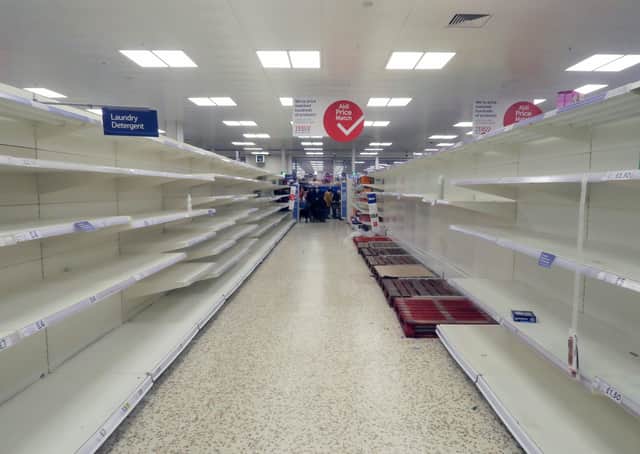 Completely cleared out supermarket shelves. Photo by Mike Hewitt/Getty Images) SUS-200320-114710001