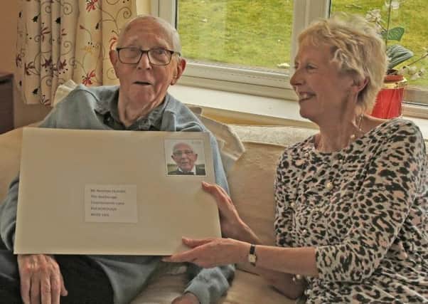 Norman Humble, a founder of the Chanctonbury Probus Club, with his 100th birthday card SUS-200324-145122001