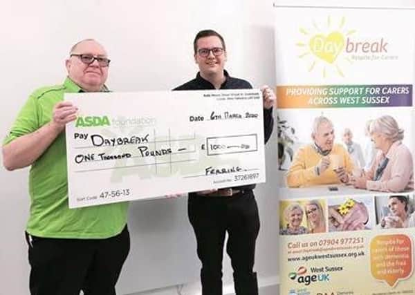 Mick Kelly from Asda hands over a cheque to Charlie Rayner at Age UK West Sussex, Brighton & Hove