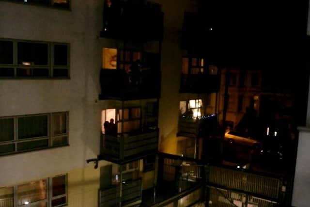Residents clapping their appreciation from a block of flats in Brighton