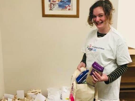 Rowan Hillier, from Age UK West Sussex, Brighton & Hove packing groceries for 'doorstep deliveries' to older people locally.
