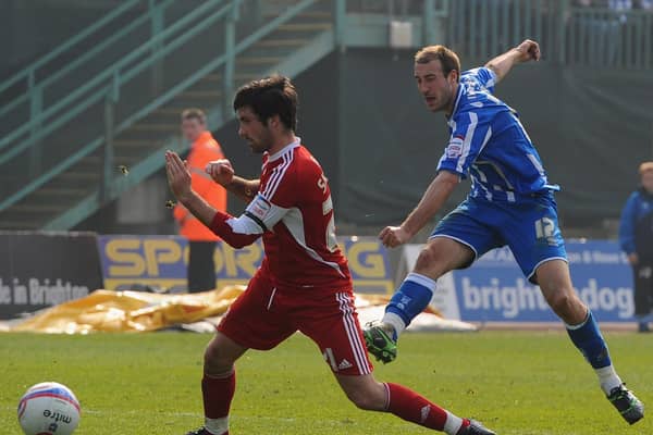 Glenn Murray of Brighton scores despite the efforts of Alan Sheehan of Swindon during the npower League One match at the Withdean Stadium on March 26, 2011