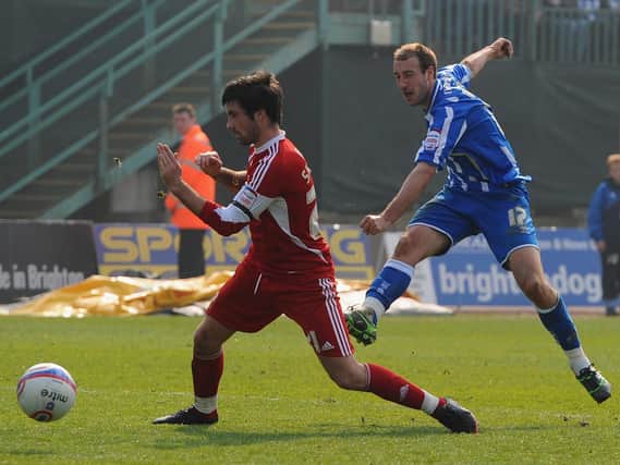 Glenn Murray of Brighton scores despite the efforts of Alan Sheehan of Swindon during the npower League One match at the Withdean Stadium on March 26, 2011