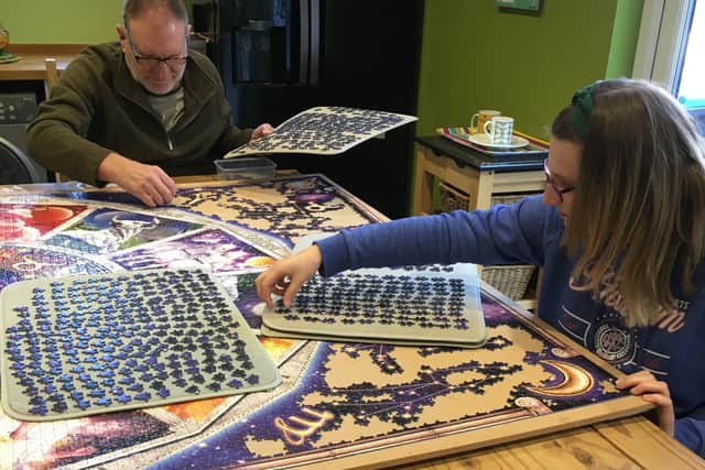 Adrian Munn and his daughter Louise working on the family jigsaw puzzle