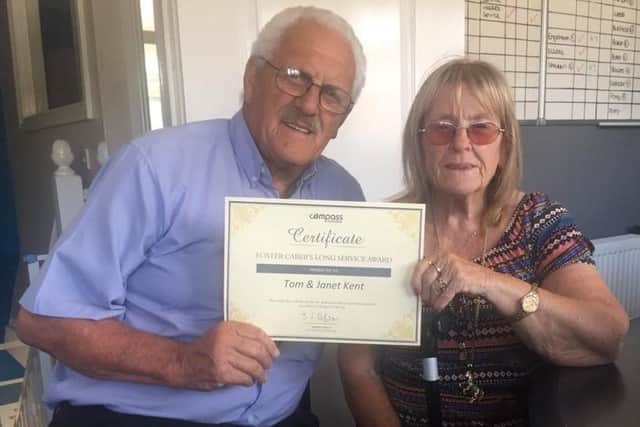 Tom and Janet Kent with their long service award from Compass Fostering