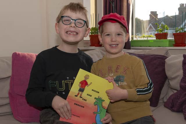 Oscar and Jake McFarlane with the book, written for Oscar