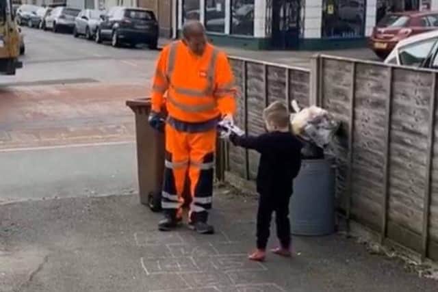 Five-year-old Buddy Strudwick thanking a hard-working dustman in Bognor by giving him an Easter egg