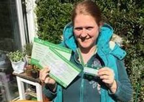 Naomi Taite of Selsey Covid Mutual Aid, which is being supported by the fund, distributing leaflets to local homes