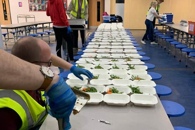 Cooking and packaging meals for students entitled to a free school lunch