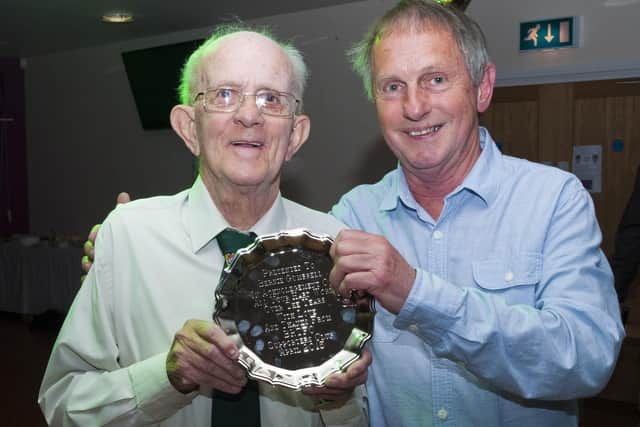 Bernie Gumbrell, left, receives a Rocks supporters' club award for his long service to BRTFC