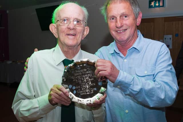 Bernie Gumbrell, left, receives an award a few years ago for his long-running service to the club