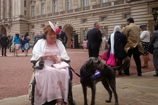 Norah Fisher with her dog, Herbie, outside Buckingham Palace