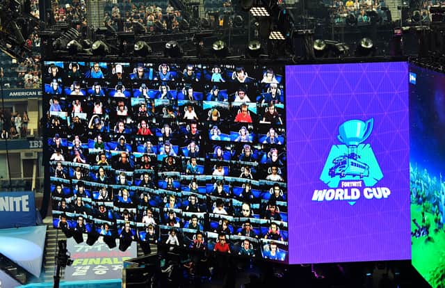 Players are seen on screen during the final of the Solo competition at the 2019 Fortnite World Cup July 28, 2019 inside of Arthur Ashe Stadium, in New York City. (Photo by Johannes EISELE / AFP)        (Photo credit should read JOHANNES EISELE/AFP via Getty Images) 775341798