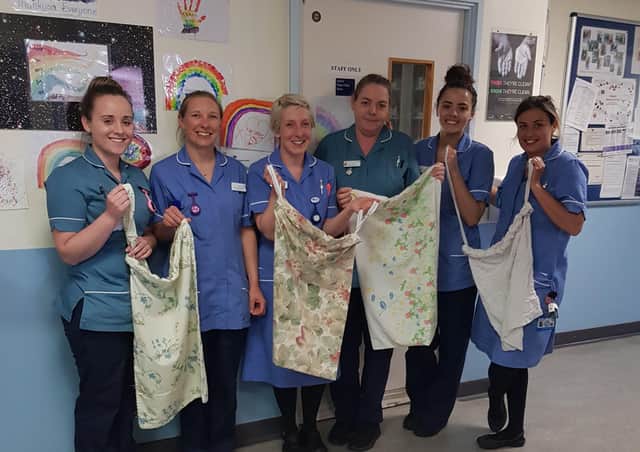 Julie's daughter Sadie Dean and colleagues at St Richard's Hospital with their bags