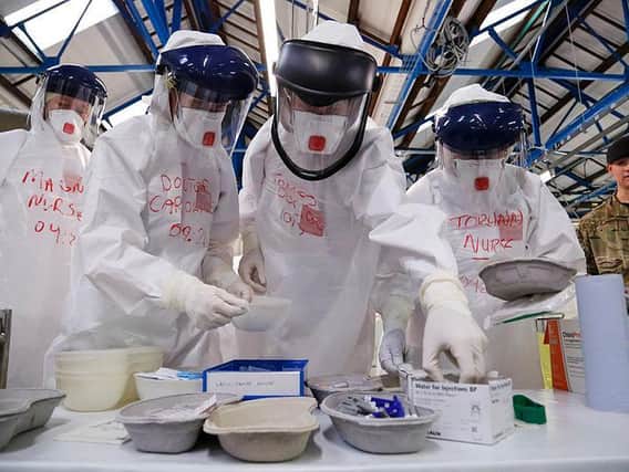 NHS workers practice in full PPE kit