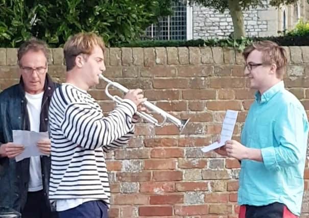 Nick Higham with Leo Higham, playing the trumpet, and Mikey Higham, holding the music