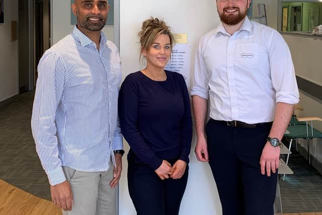 Rishi Patel, Rustington Specsavers store director, left, and regional manager James Griffiths with manager Claire Durick-Glen, a picture taken before social distancing restrictions were put in place