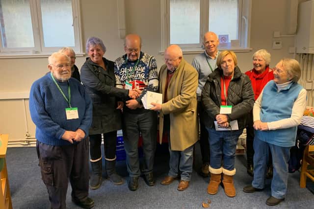 Lodge Secretary, Tony Hubbard handing 400 of gift vouchers at Christmas which were used by the Foodbank to give Christmas presents to young adults in the Midhurst area. The picture was taken prior to social distancing measures.