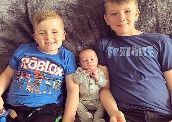 William with his new big brothers, Beau (left) and Tyler (right)