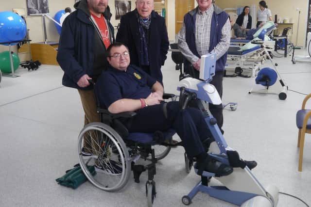Steve on the static cycle with Care for Veterans volunteer Brian, Christopher Timothy and his father Peter Boylan