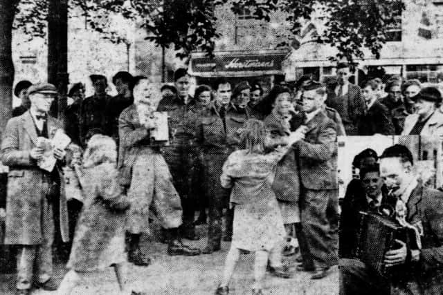 Dancing in the street in Carfax on VE Day in 1945 and, inset, the lone accordion player who provided the music