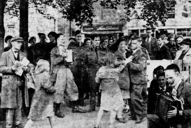 Dancing in Carfax on VE Day in 1945 and, inset, the lone accordion player who provided the music