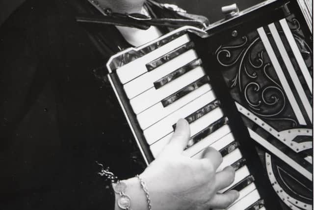 Mrs Cole (Squeezebox) with her accordion, entertained the troops at The George, every nationality, including the many Canadians in this area, awaiting invasion in 1944