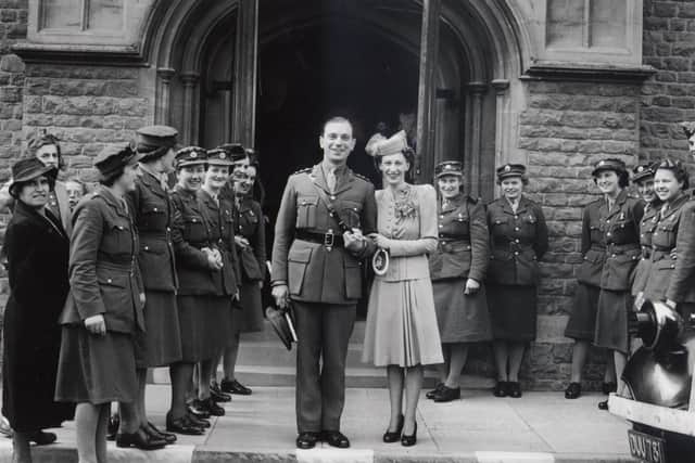 Miss Caroll of ATS Office, Broadbridge Heath Camp, is married to her Captain at St John the Evangilist, Springfield Road, Horsham in 1942, and a guard of ATS is ready with confetti