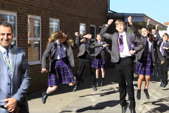Headteacher of Worthing High School, Pan Panayiotou, celebrating their latest Ofsted result with pupils