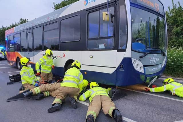 Crews rescuing the dog trapped under the bus in West Sussex