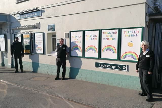 Jethro Kandasamy, Karl Wingate and Gill English with their messages of support at Barnham railway station