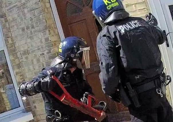 Police conducting the warrant on Wednesday. Photo: Sussex Police