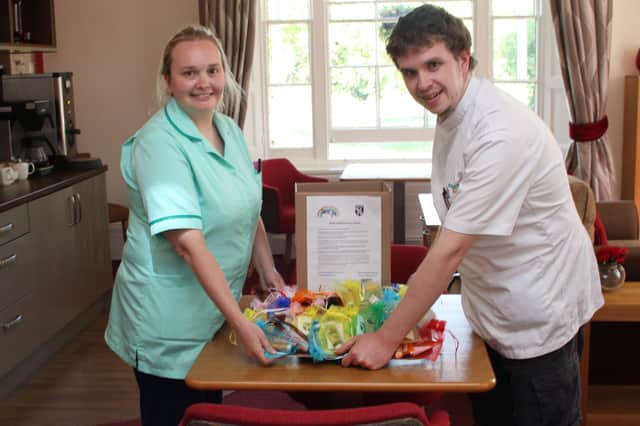 Staff at Red Oaks Care Home in Henfield with the surprise parcel from the Henfield under-8s football team SUS-200519-143706001