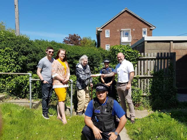 PSCO Shah and PCSO Nasir and Albert's neighbours Nathan Weir and Georgia Webster as Mark Straughan hands a cheque to Albert. Picture: Hastings Police