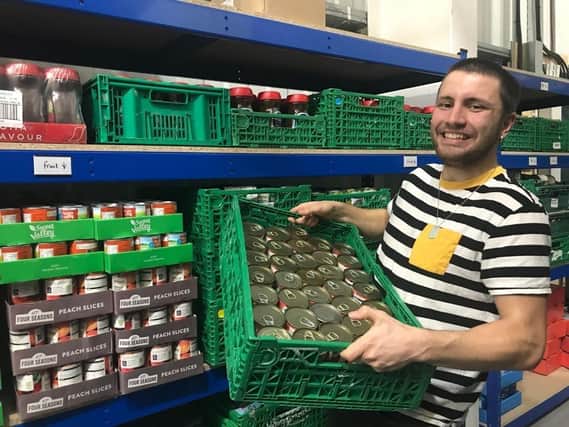 Alfie Head, 21, volunteering at the Hastings Foodbank Warehouse