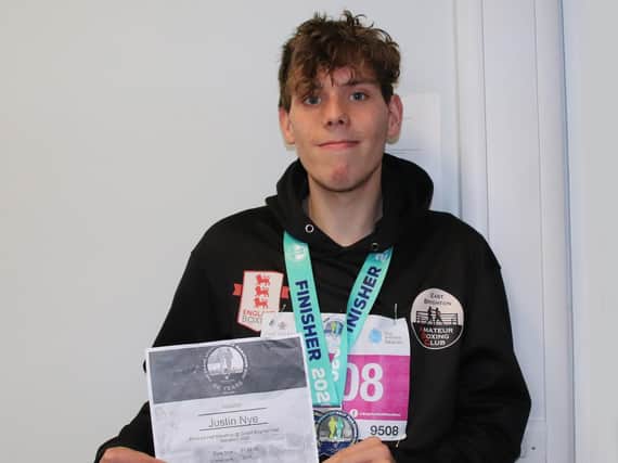 Justin is pictured with his Brighton Half Marathon medal and certificate.