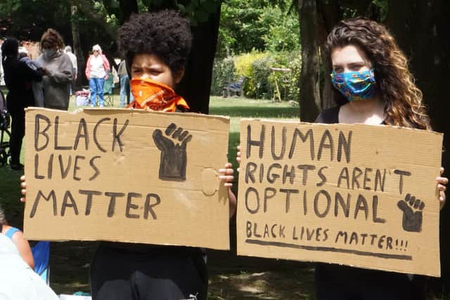 Two women holding Black Lives Matter signs