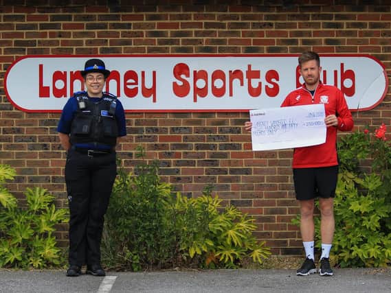 Tom Cherryman receiving the cheque from PCSO Katie Clarke / Photo by Andy Pelling