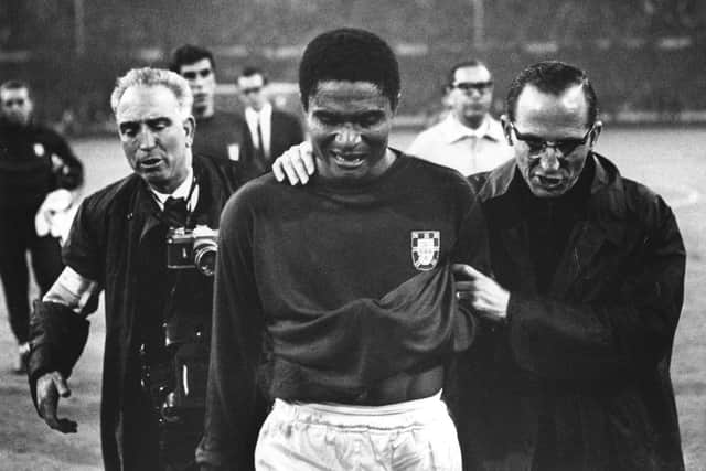 Eusebio is led off the pitch in tears after Portugal's defeat to England in the 1966 World Cup / Picture: Getty