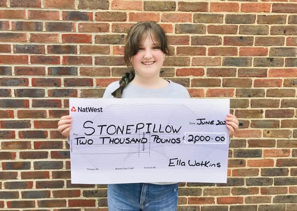 Ella Watkins with her cheque for Stonepillow