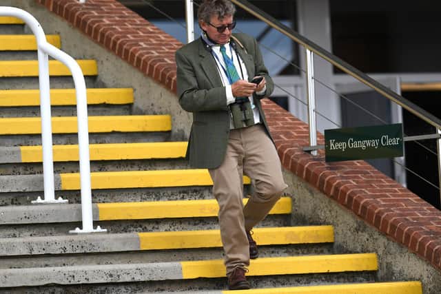 Trainer Mark Johnston in splendid isolation in the stand at Goodwood as crowd-free racing is staged / Picture: Getty
